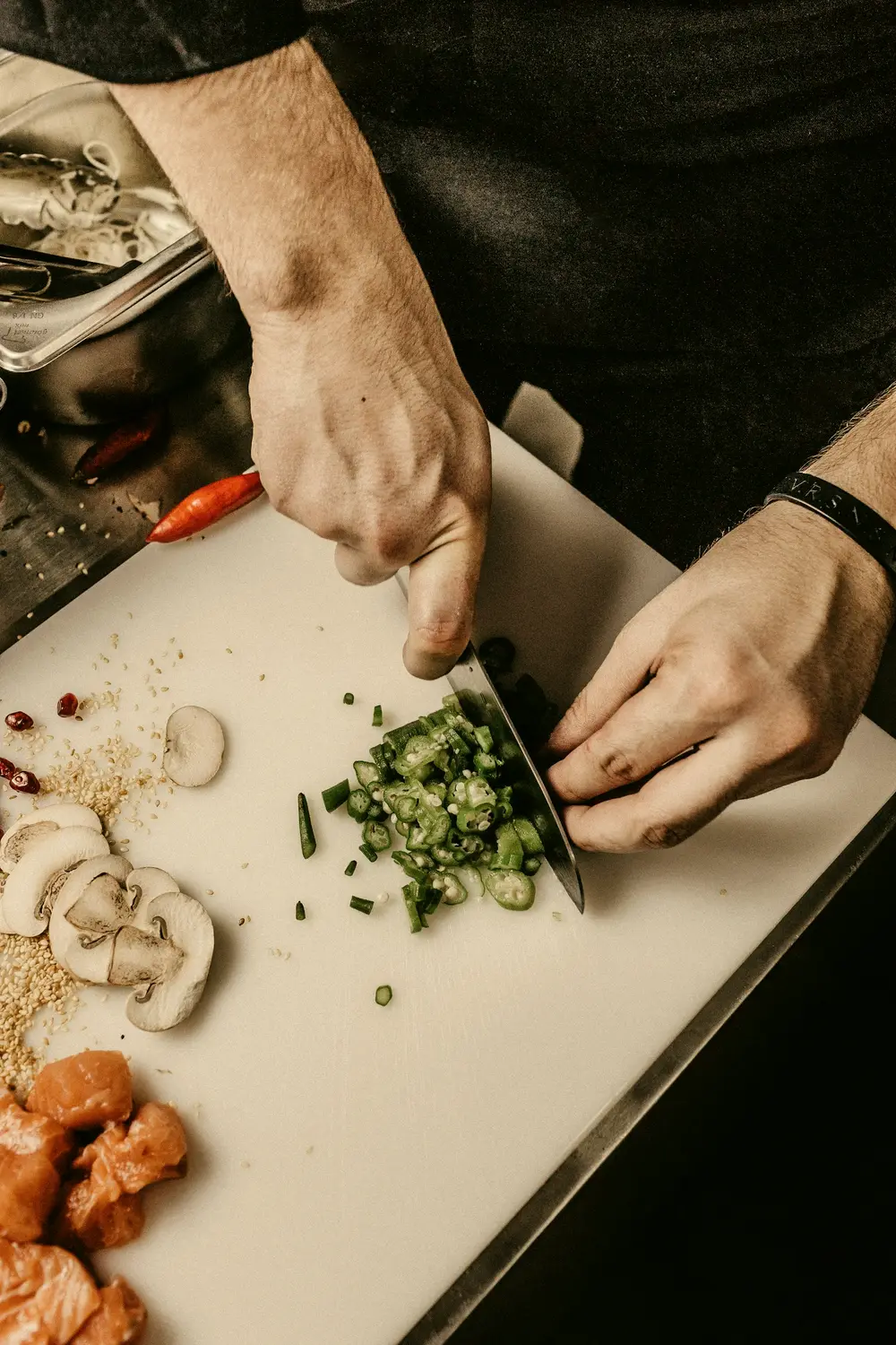 Herbs being chopped on a white board